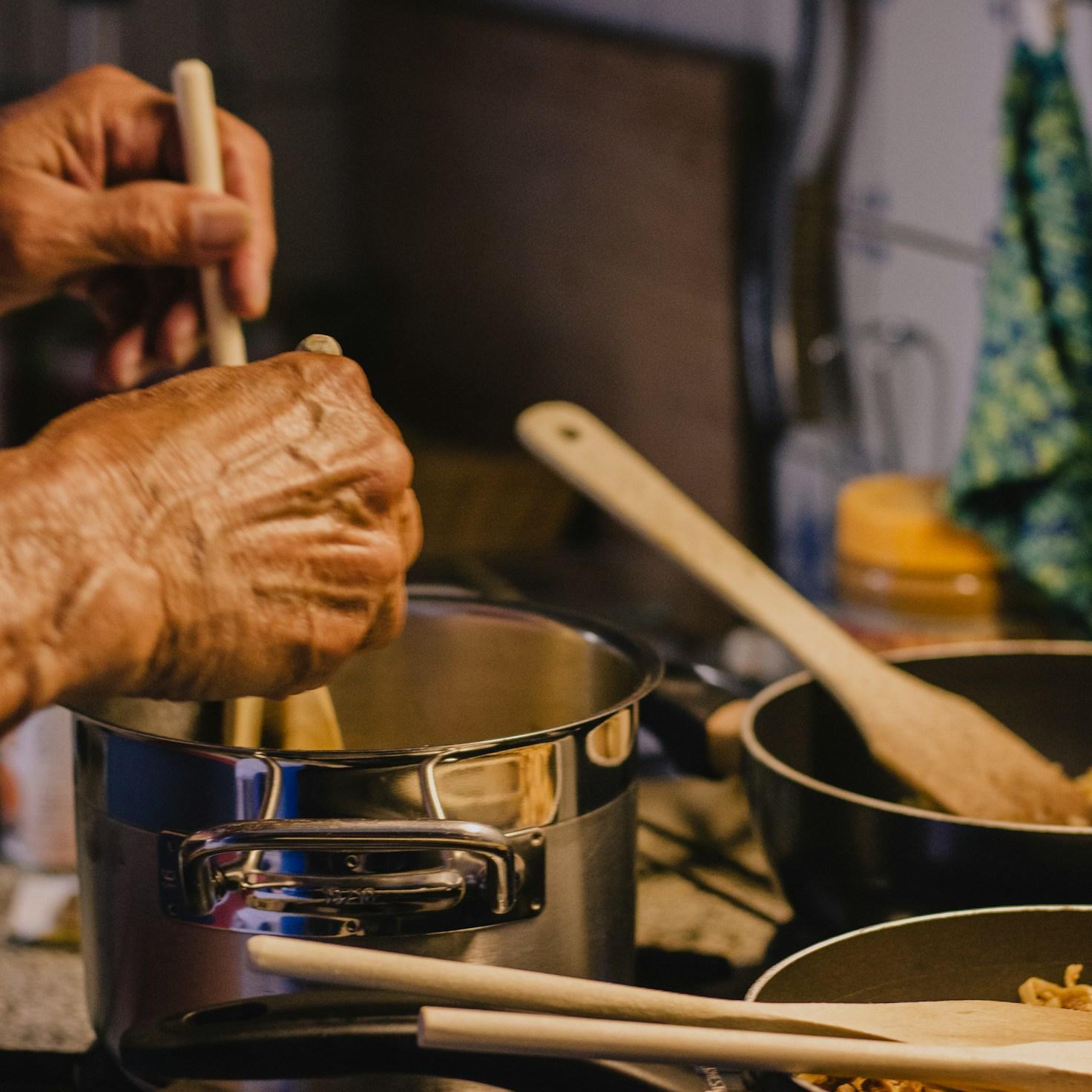 Diverse group of community members sharing a meal, highlighting the connections built through collaborative cooking